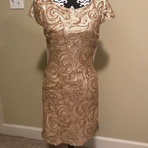Boutique dress, with tags, gold with sheer back.